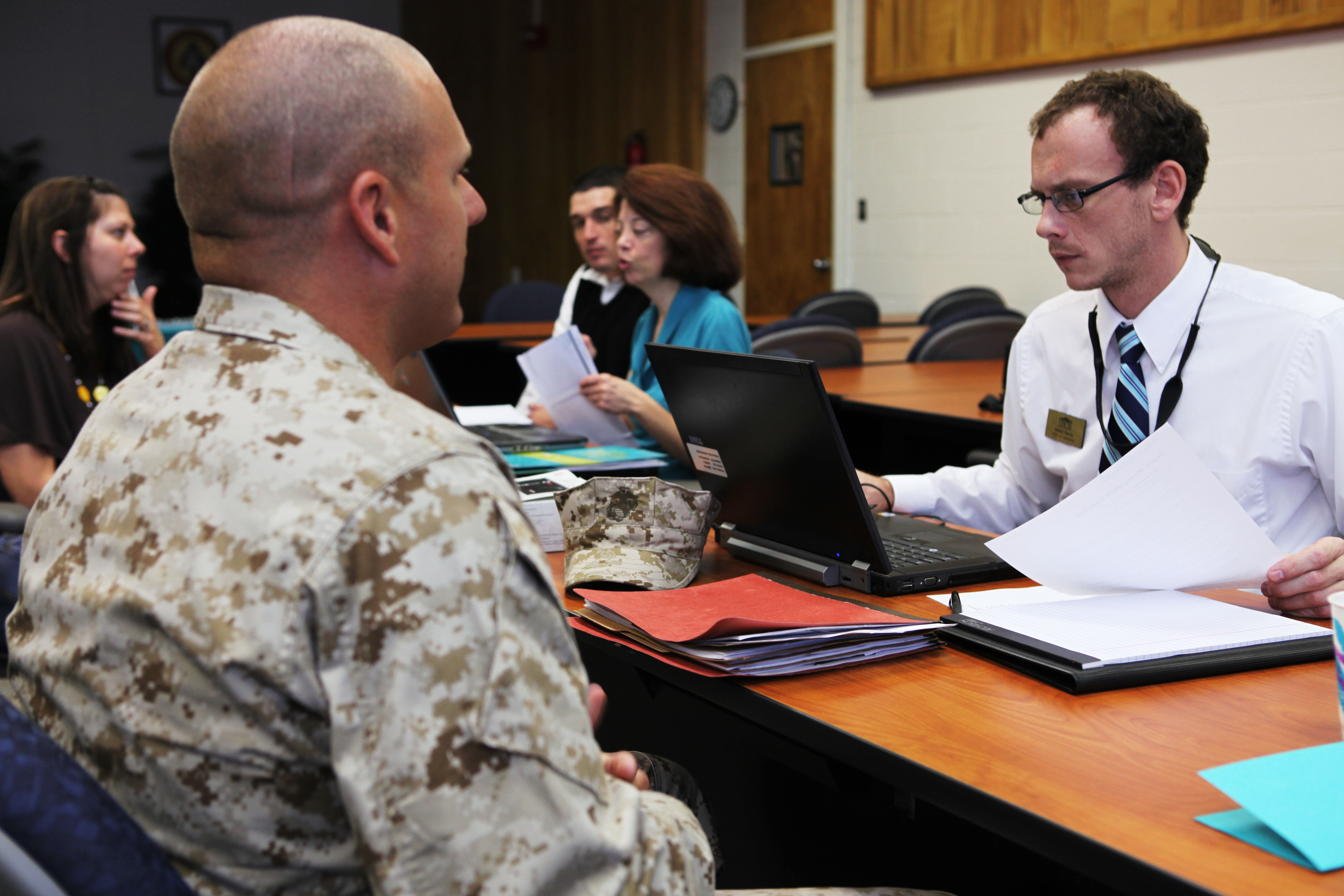 A service member consults with personnel