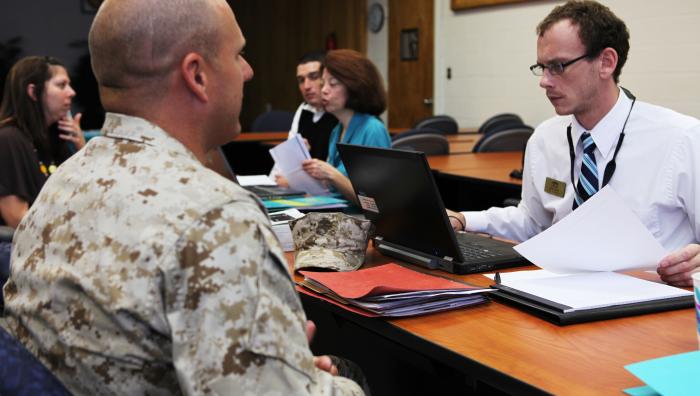 A service member consults with personnel